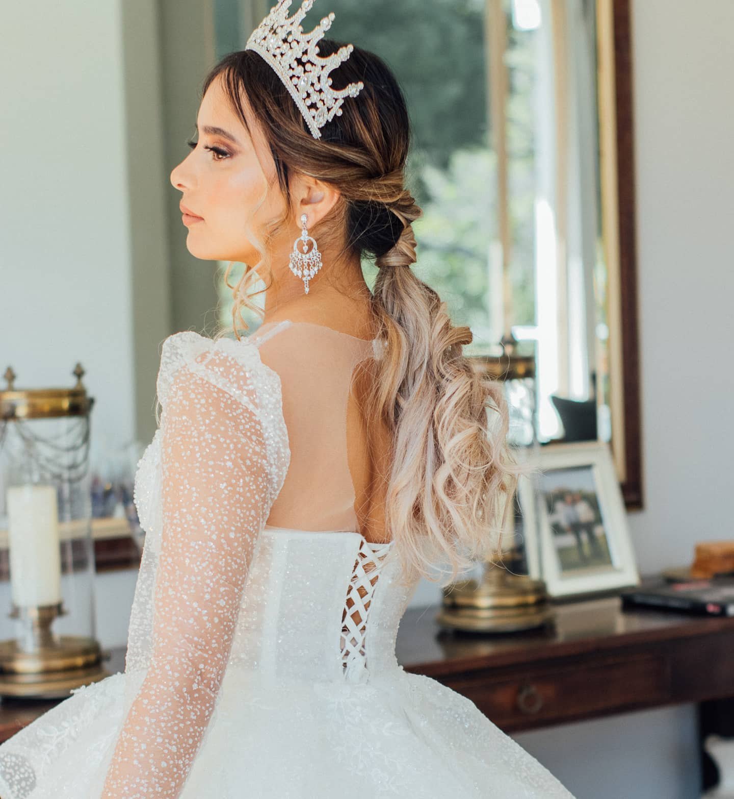 Bride in a crystal crown with a half-up, waved ponytail